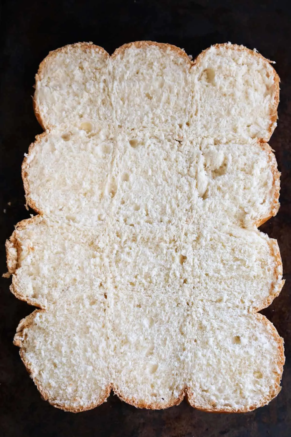 bottoms of dinner rolls on a baking sheet