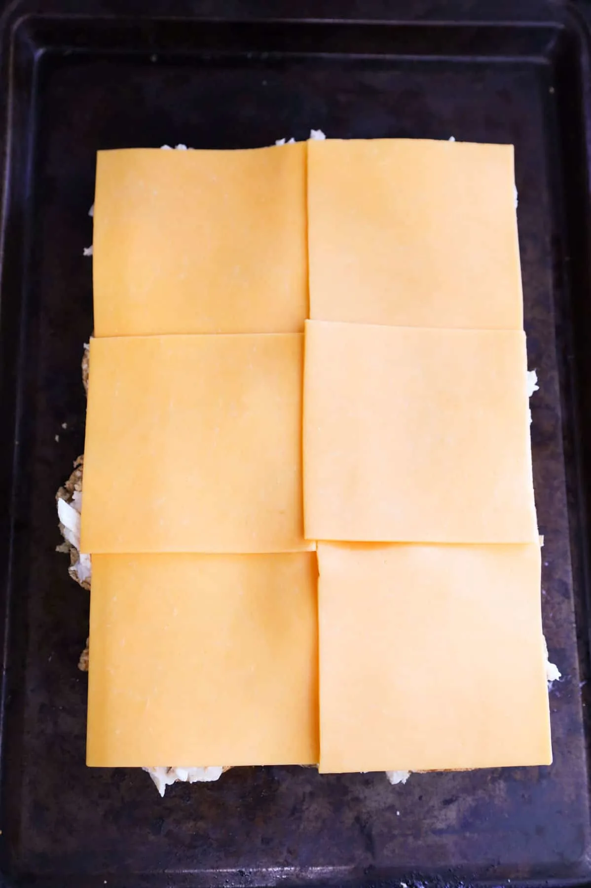 cheddar cheese slices on top of slider rolls