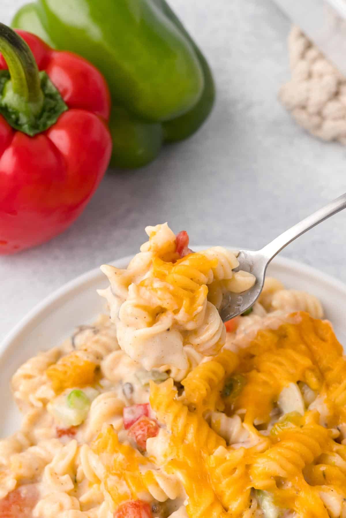 Chicken Pasta Casserole is a creamy casserole loaded with chunks of chicken, rotini noodles, mixed vegetables, cream of mushroom soup, cream of chicken soup and cheddar cheese.