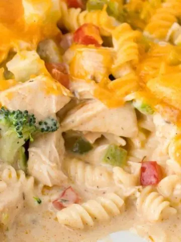 Chicken Pasta Casserole is a creamy casserole loaded with chunks of chicken, rotini noodles, mixed vegetables, cream of mushroom soup, cream of chicken soup and cheddar cheese.