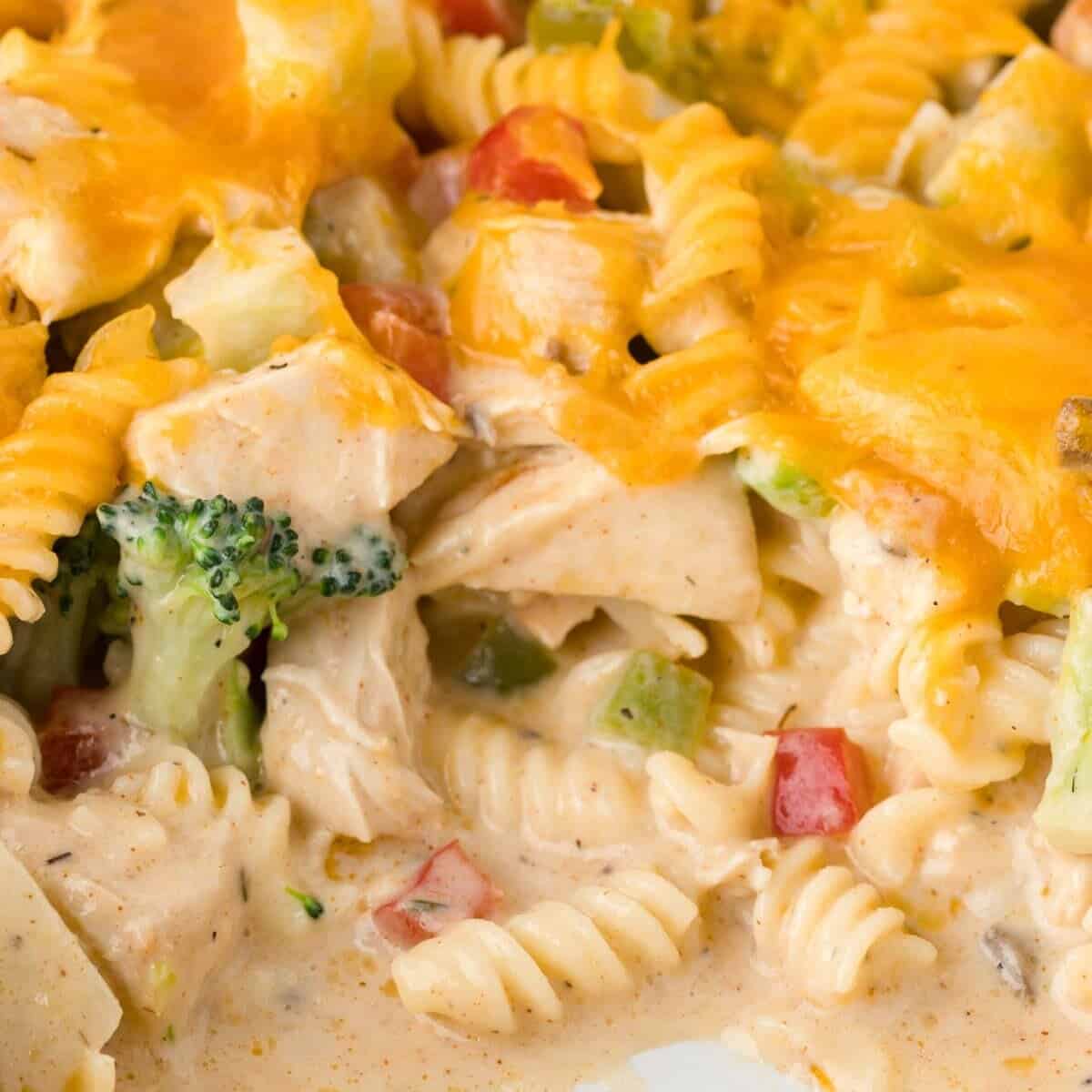 Chicken Pasta Casserole is a creamy casserole loaded with chunks of chicken, rotini noodles, mixed vegetables, cream of mushroom soup, cream of chicken soup and cheddar cheese.