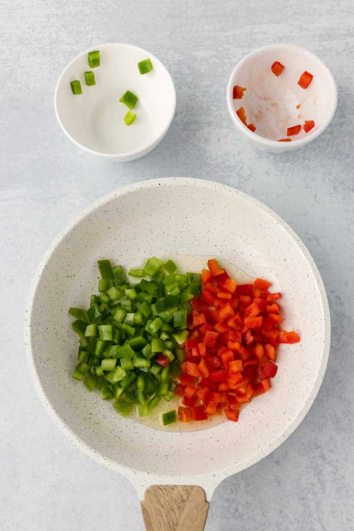 diced red and green bell peppers in a skillet
