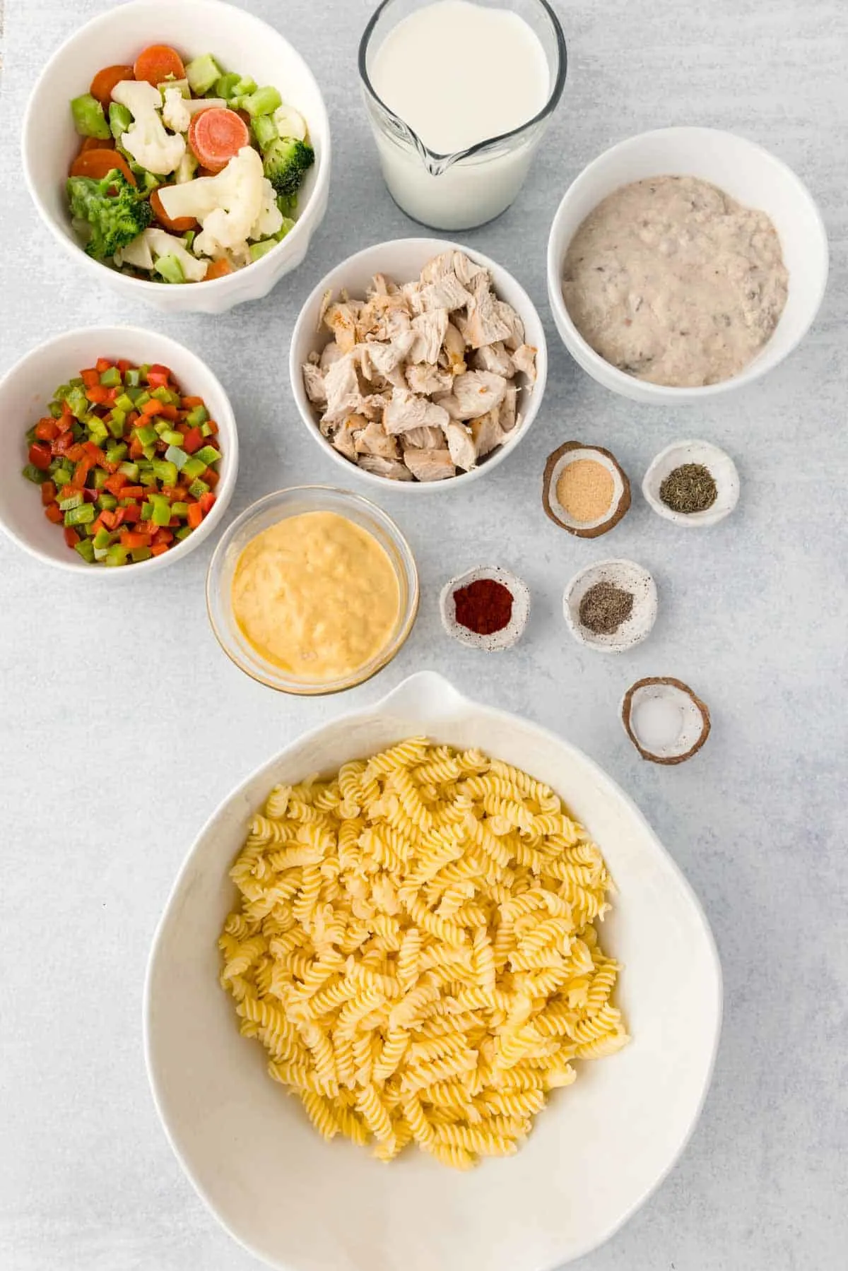 pasta casserole ingredients in prep bowls