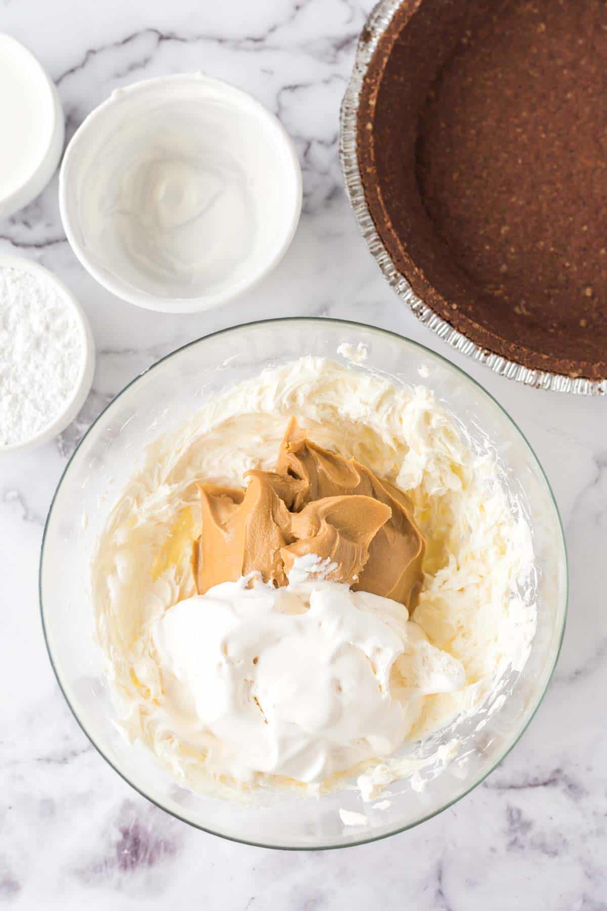 cool whip, peanut butter and cream cheese in a mixing bowl