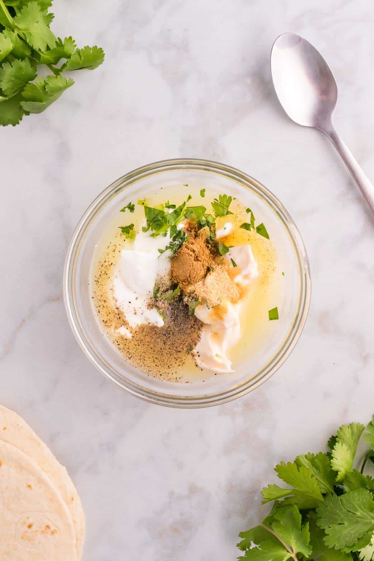 Greek yogurt, mayo, lime juice, cilantro, cumin, garlic powder, salt and pepper in a bowl