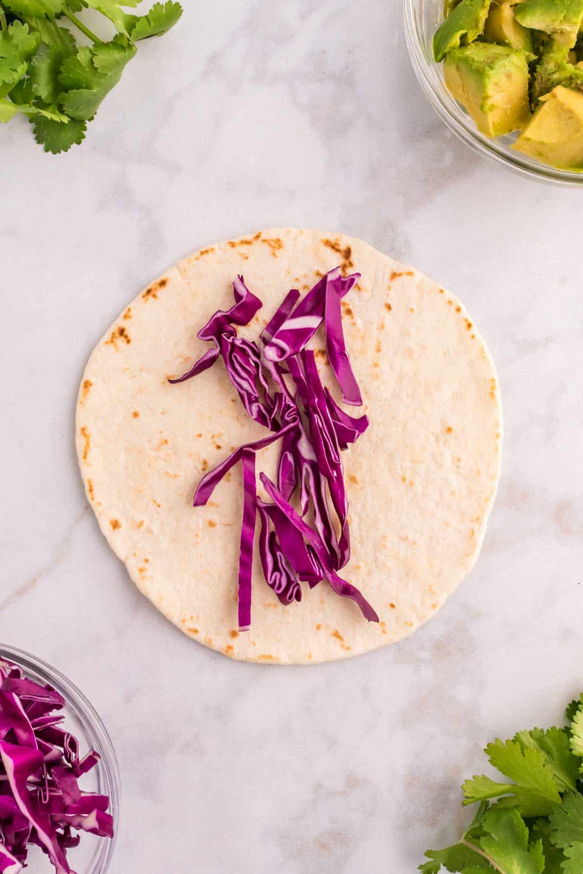 sliced red cabbage on a flour tortilla