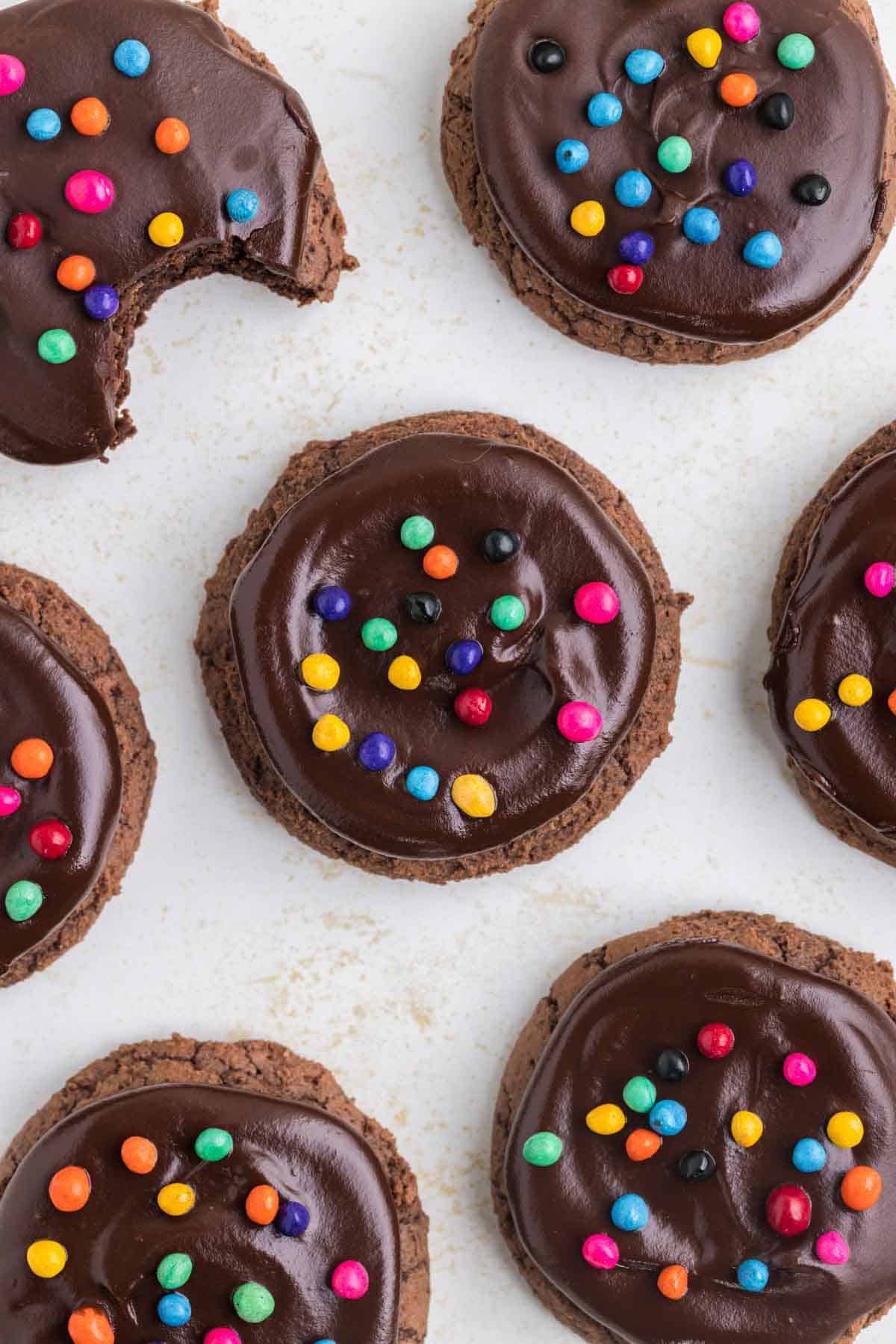 Cosmic Brownie Cookies are rich and chewy cookies made with boxed brownie mix and topped with chocolate ganache and colourful candy coated chocolate chips.