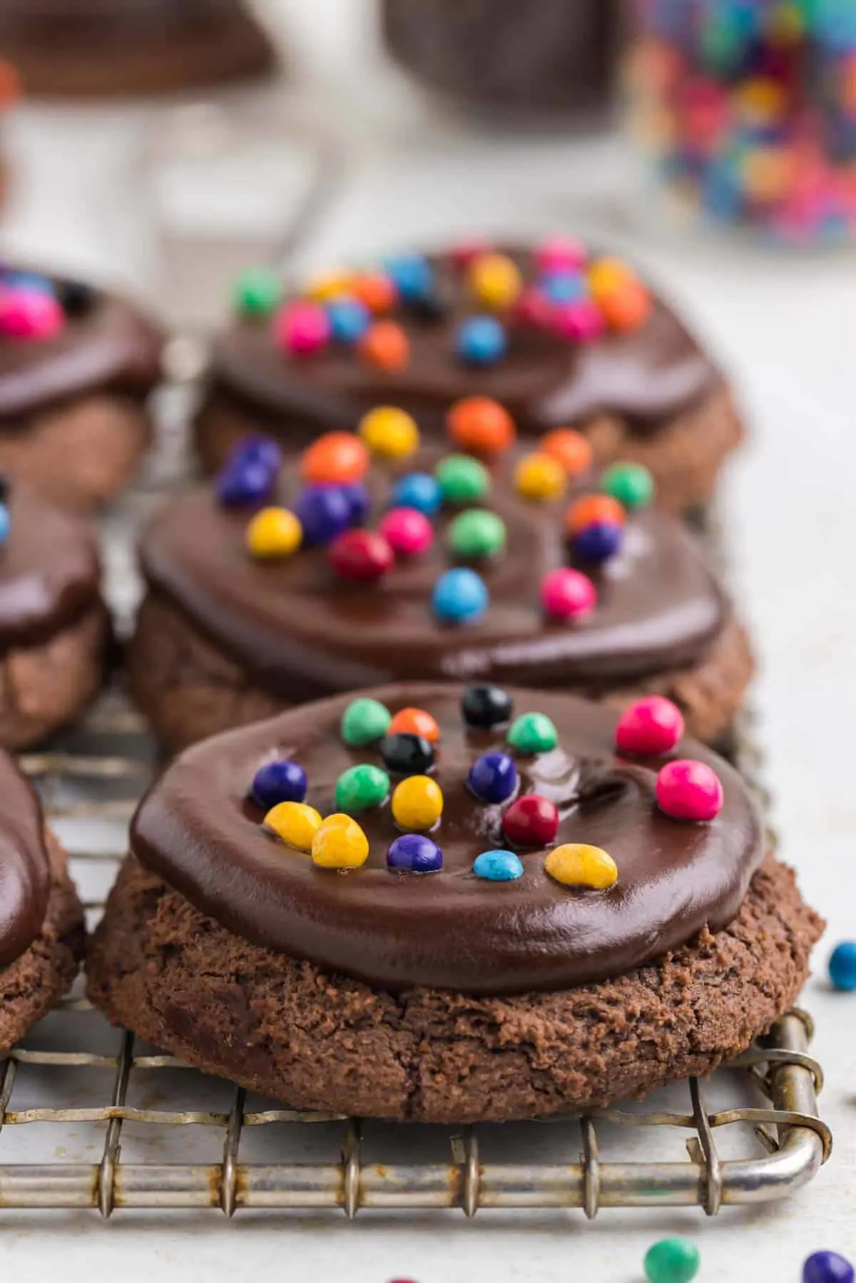 Cosmic Brownie Cookies are rich and chewy cookies made with boxed brownie mix and topped with chocolate ganache and colourful candy coated chocolate chips.
