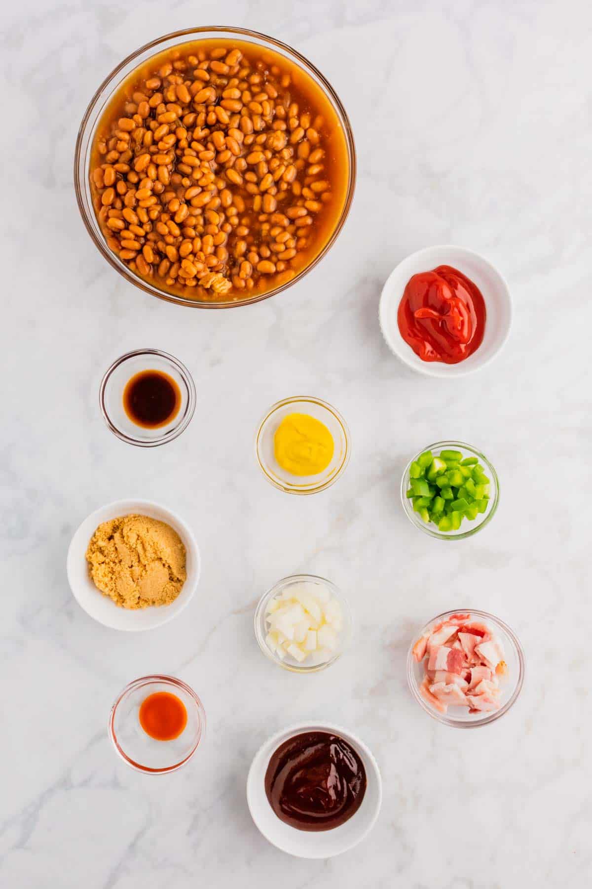 crock pot baked beans ingredients in prep bowls.