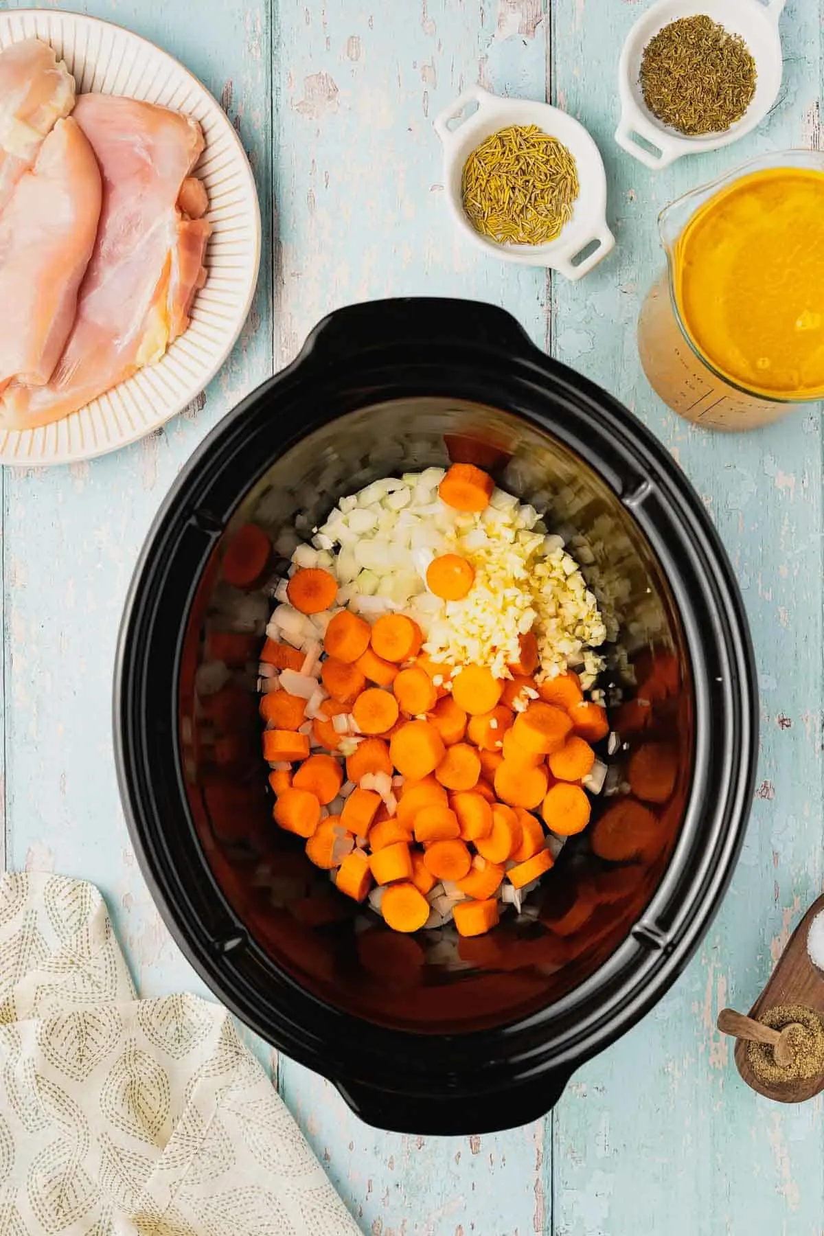 sliced carrots and diced onions in a crock pot