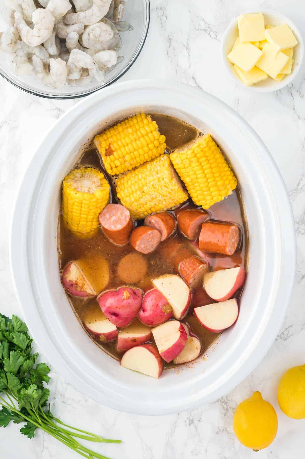 water, seasoning, corn, potatoes and sliced sausage in a Crock Pot