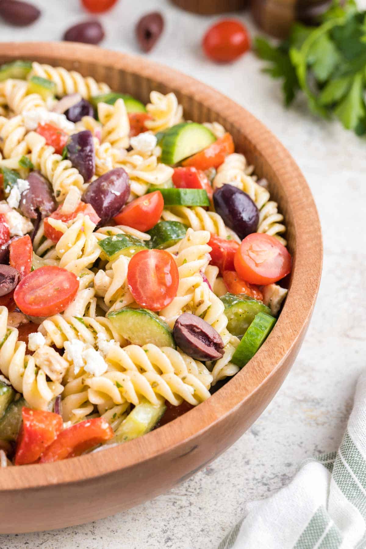 Greek Pasta Salad is a colourful pasta salad recipe loaded with cucumbers, red bell peppers, grape tomatoes, red onions, Kalamata olives and feta cheese all tossed in a homemade dressing.