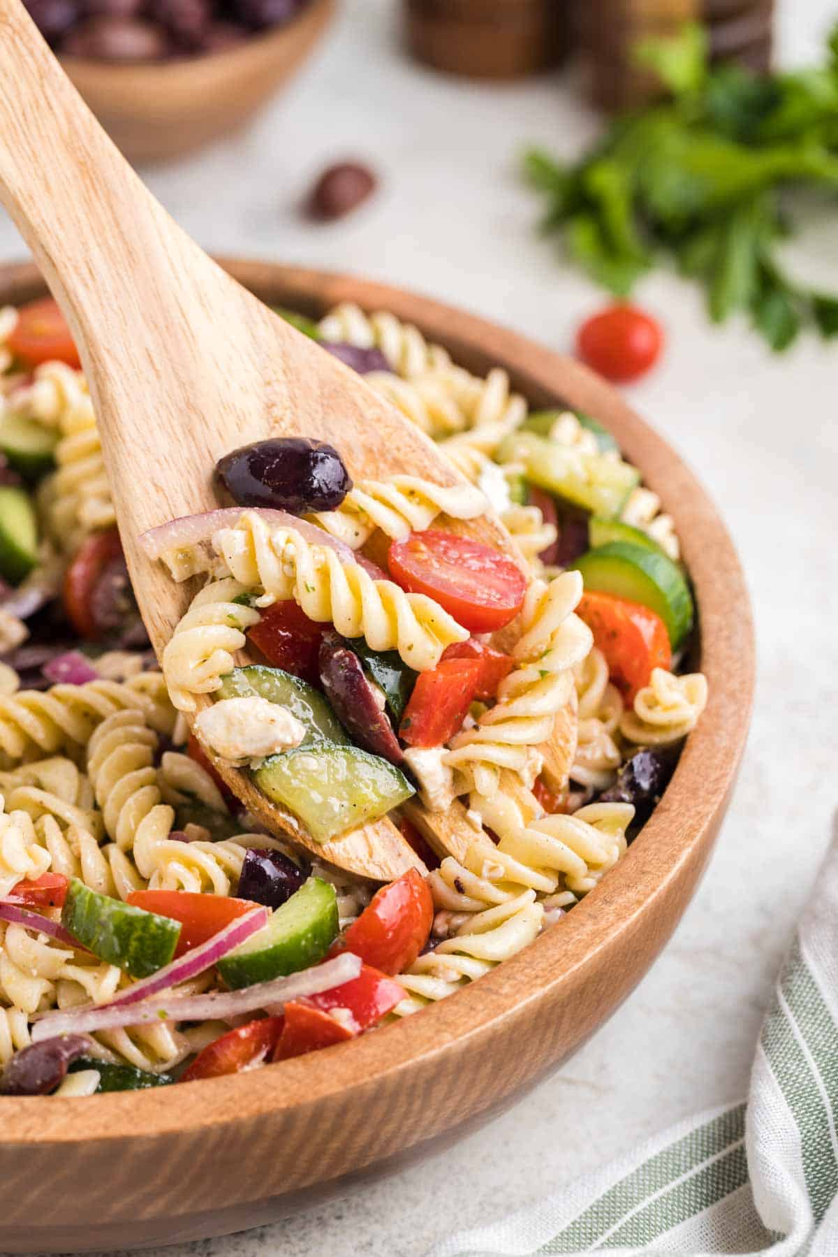 Greek Pasta Salad is a colourful pasta salad recipe loaded with cucumbers, red bell peppers, grape tomatoes, red onions, Kalamata olives and feta cheese all tossed in a homemade dressing.