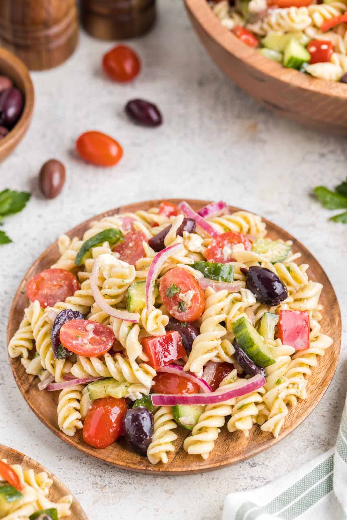 Greek Pasta Salad is a colourful pasta salad recipe loaded with cucumbers, red bell peppers, grape tomatoes, red onions, Kalamata olives and feta cheese all tossed in a homemade dressing.