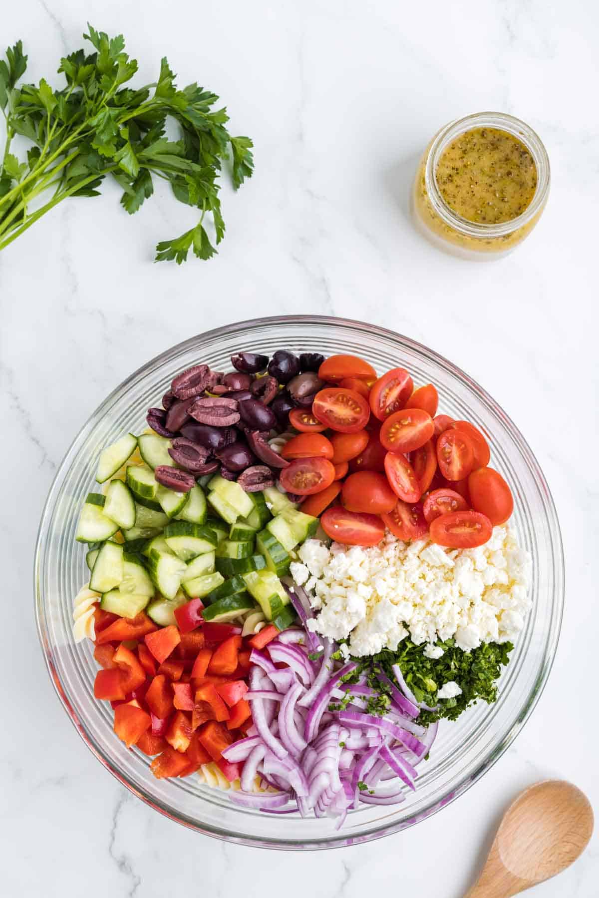 chopped veggies for greek salad in a mixing bowl