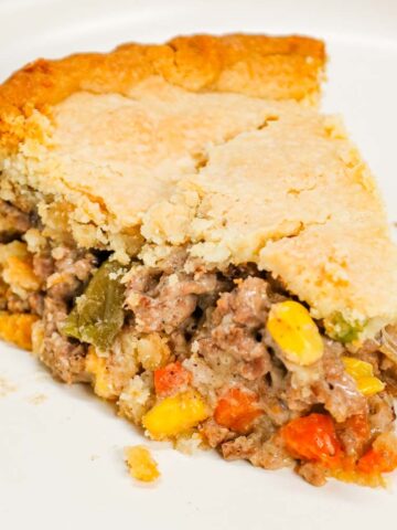 Ground Beef Pot Pie is an easy weeknight dinner recipe made with store bought pie crust and filled with ground beef and mixed vegetables all tossed in cream of mushroom soup.