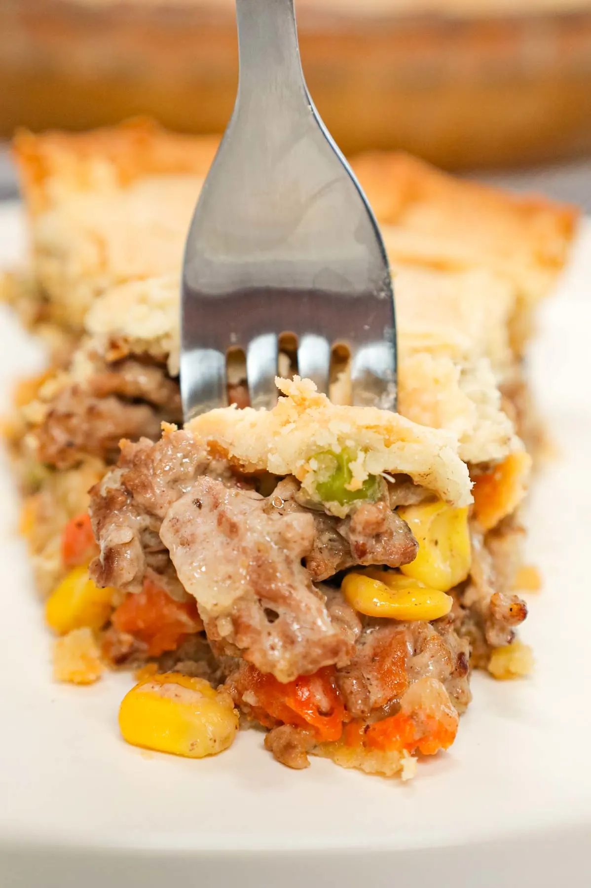 Ground Beef Pot Pie is an easy weeknight dinner recipe made with store bought pie crust and filled with ground beef and mixed vegetables all tossed in cream of mushroom soup.