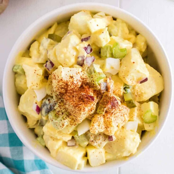 Southern Potato Salad is a classic side dish recipe loaded with cubes of russet potatoes, chopped hard boiled eggs, celery, red onions and dill pickles all tossed in a mayo based dressing and seasoned with paprika.