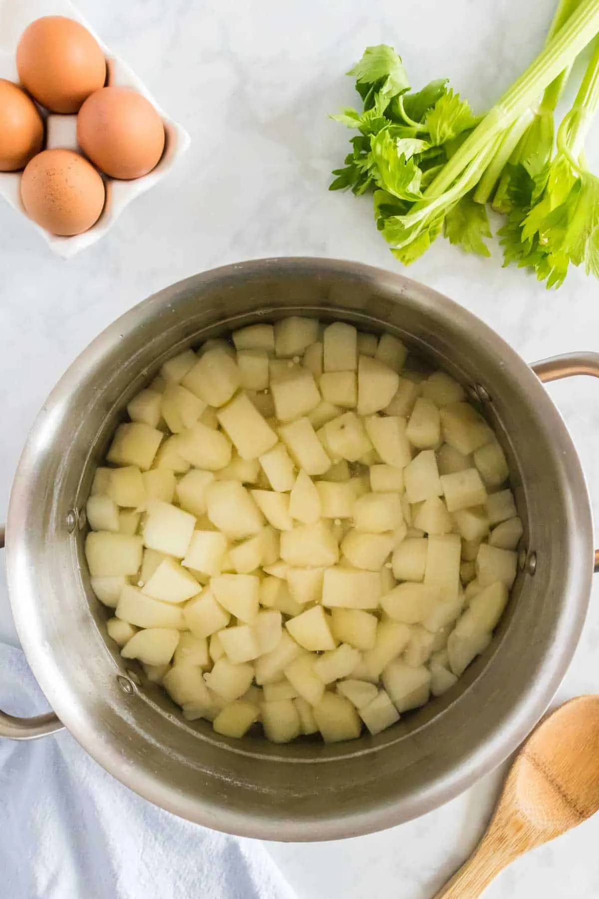 potato cubes cooking in a large pot of water