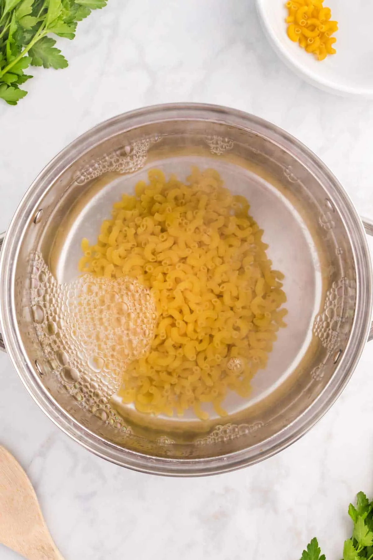 macaroni noodles cooking in a large pot of water