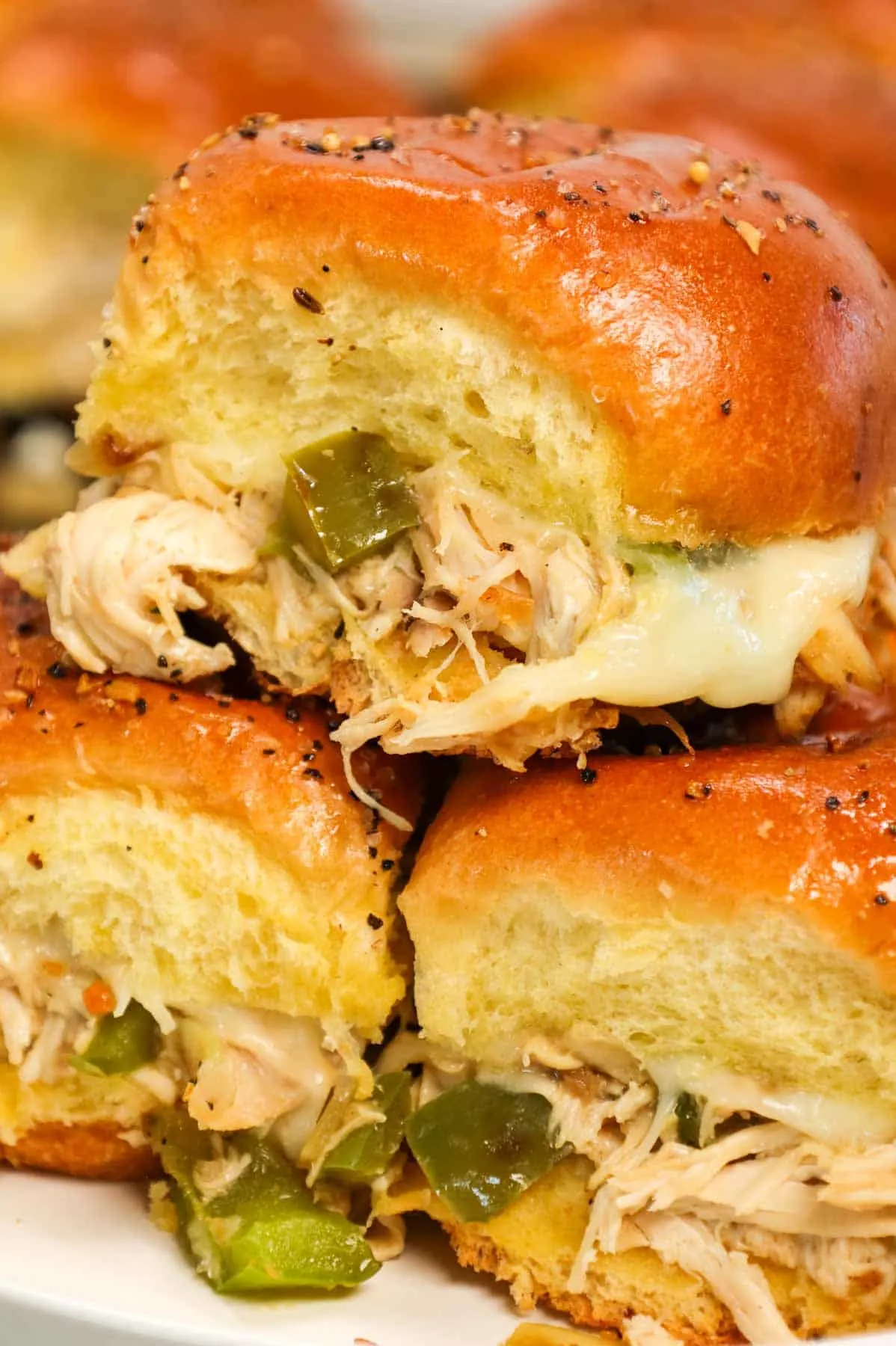 Chicken Philly Sliders are delicious mini sandwiches on brioche dinner rolls loaded with shredded chicken, green bell peppers, onions and Provolone cheese.