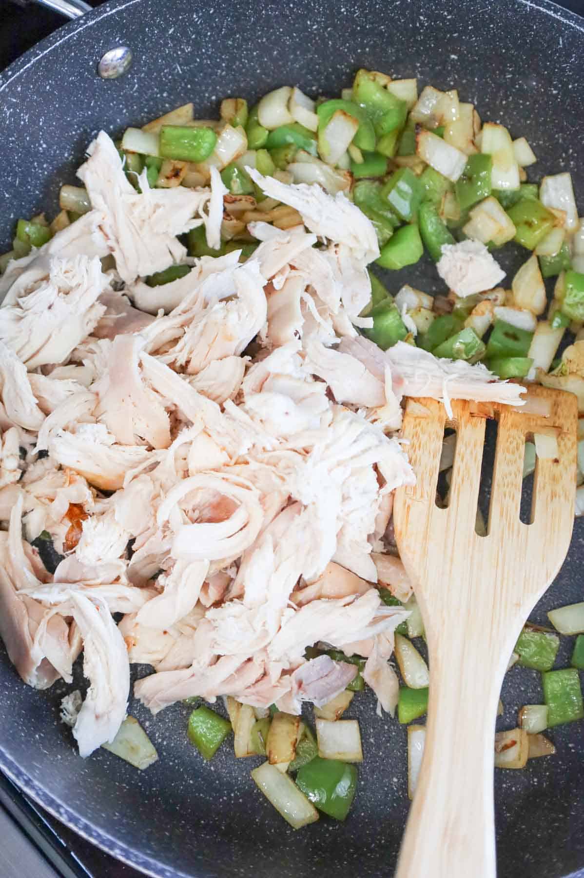 shredded chicken, diced green peppers and diced onions in a skillet