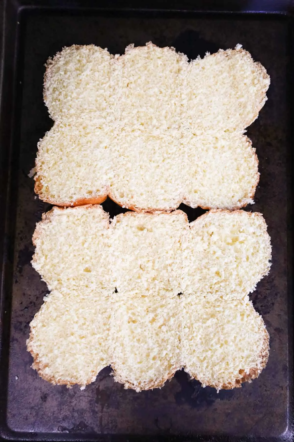 bottom buns on a baking sheet
