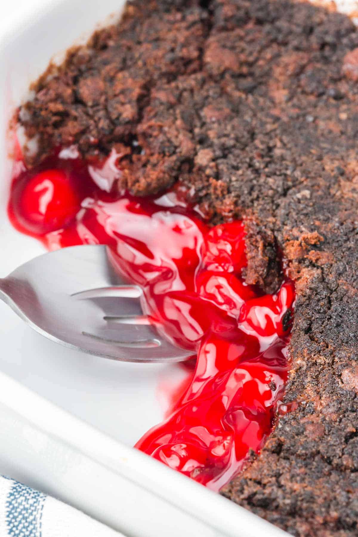 Chocolate Cherry Dump Cake is an easy dessert recipe made with cherry pie filling, Devils Food chocolate cake mix, butter and Oreo thins cookies.