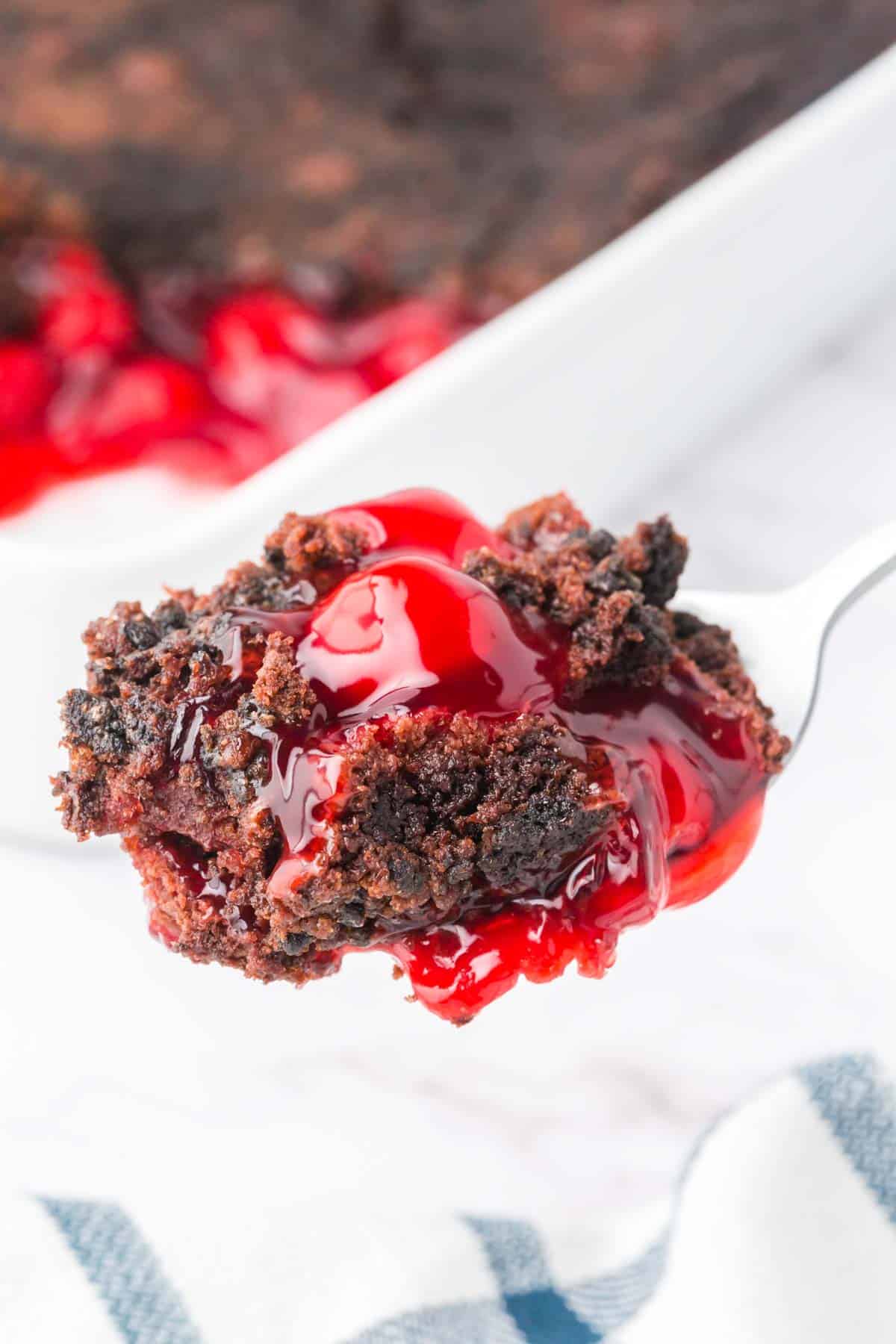 Chocolate Cherry Dump Cake is an easy dessert recipe made with cherry pie filling, Devils Food chocolate cake mix, butter and Oreo thins cookies.