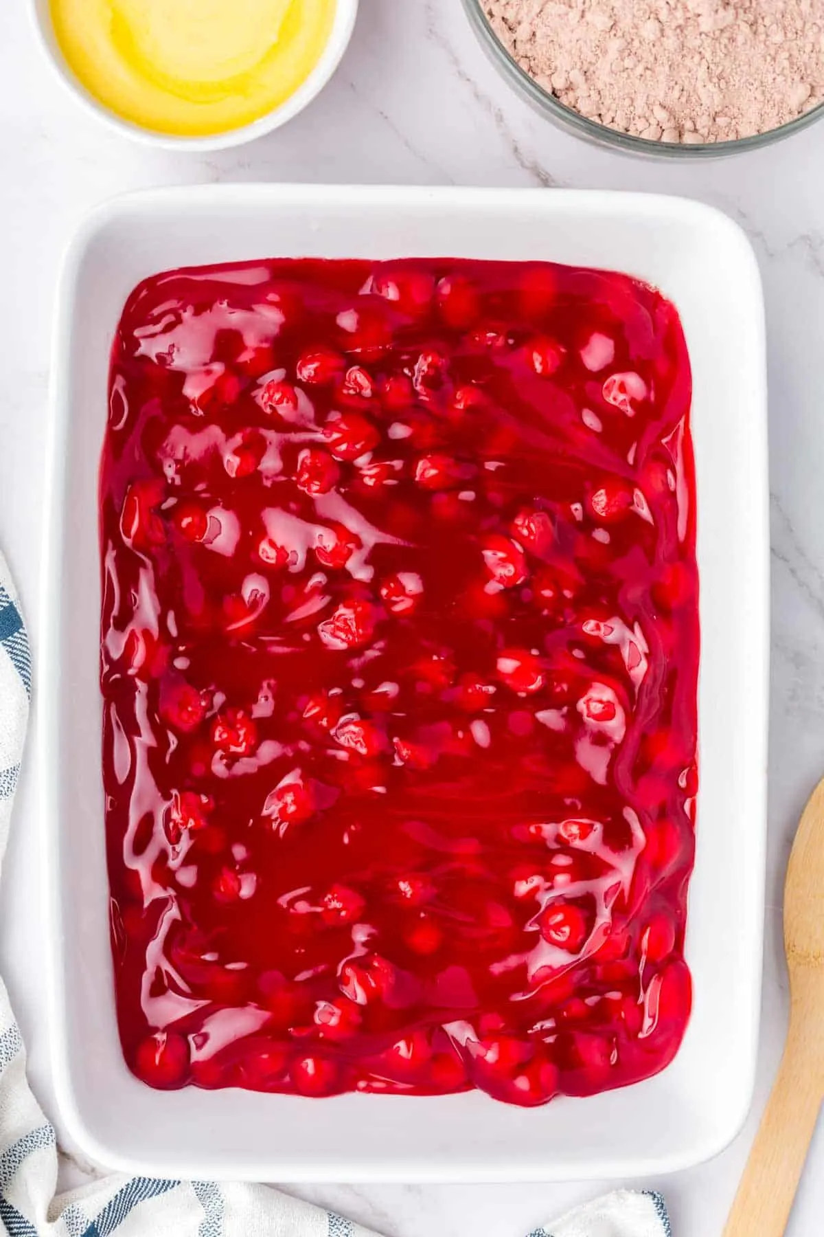 cherry pie filling spread in a baking dish