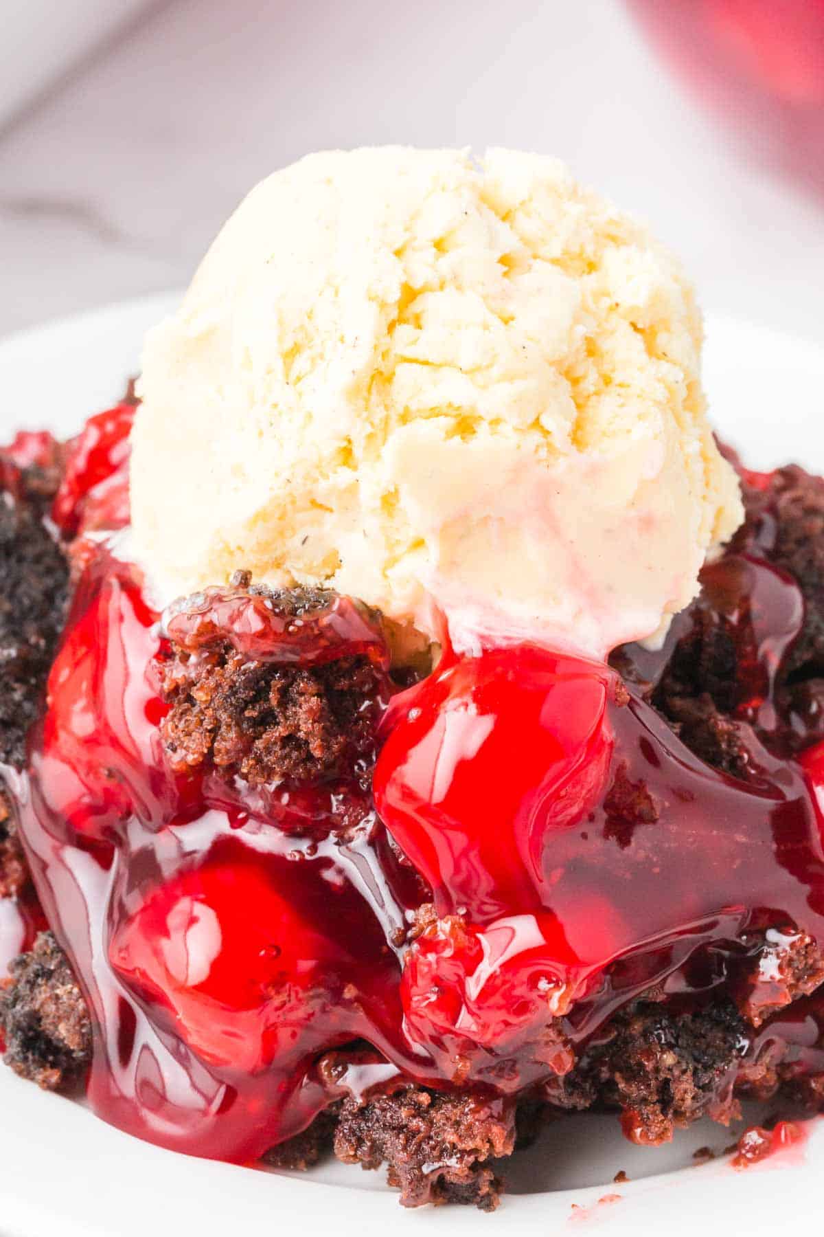 Chocolate Cherry Dump Cake is an easy dessert recipe made with cherry pie filling, Devils Food chocolate cake mix, butter and Oreo thins cookies.