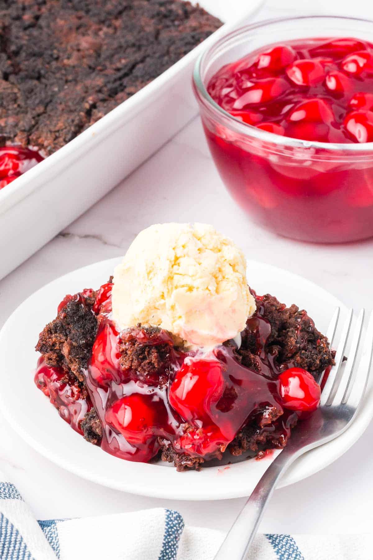 Chocolate Cherry Dump Cake is an easy dessert recipe made with cherry pie filling, Devils Food chocolate cake mix, butter and Oreo thins cookies.