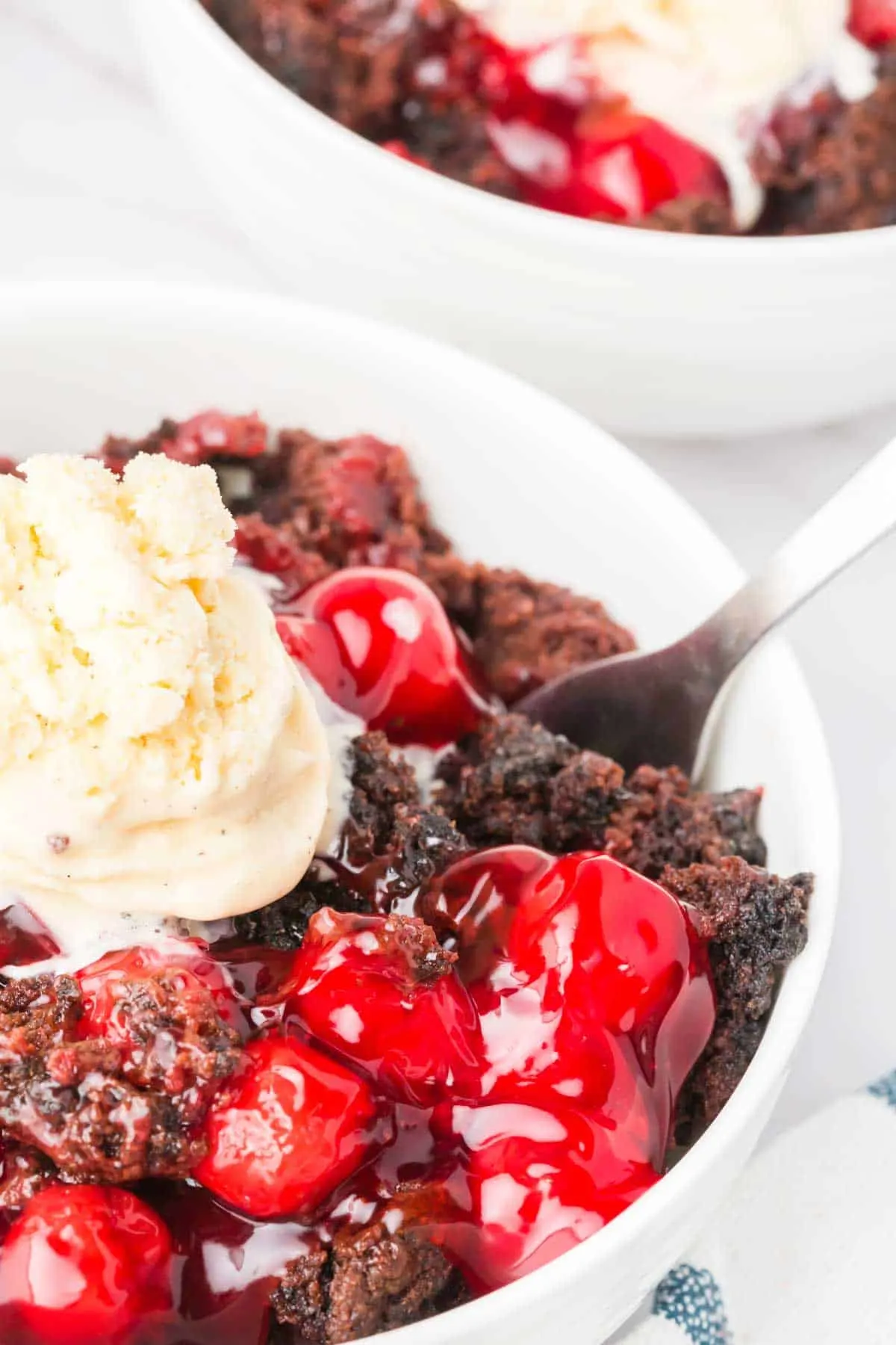 Chocolate Cherry Dump Cake is an easy dessert recipe made with cherry pie filling, Devils Food chocolate cake mix, butter and Oreo thins cookies.