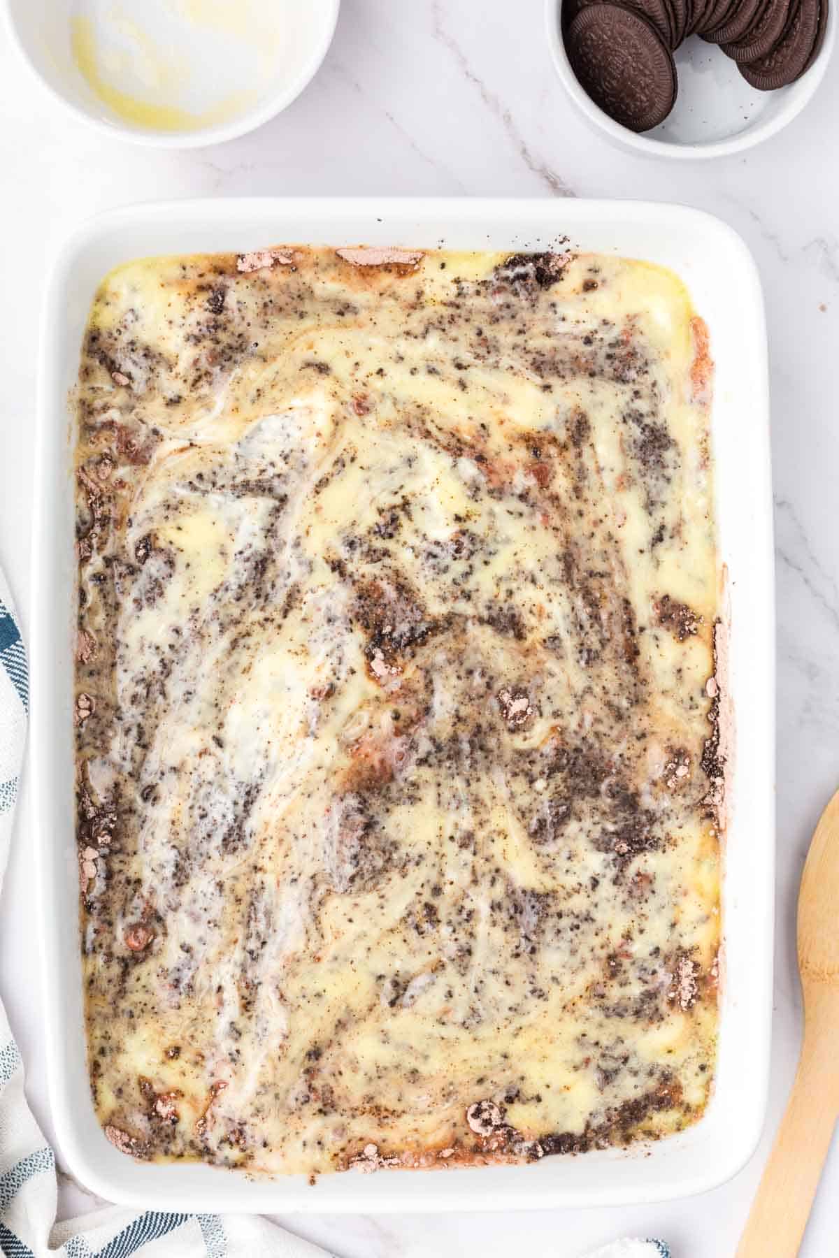 melted butter poured over dump cake ingredients in a baking dish