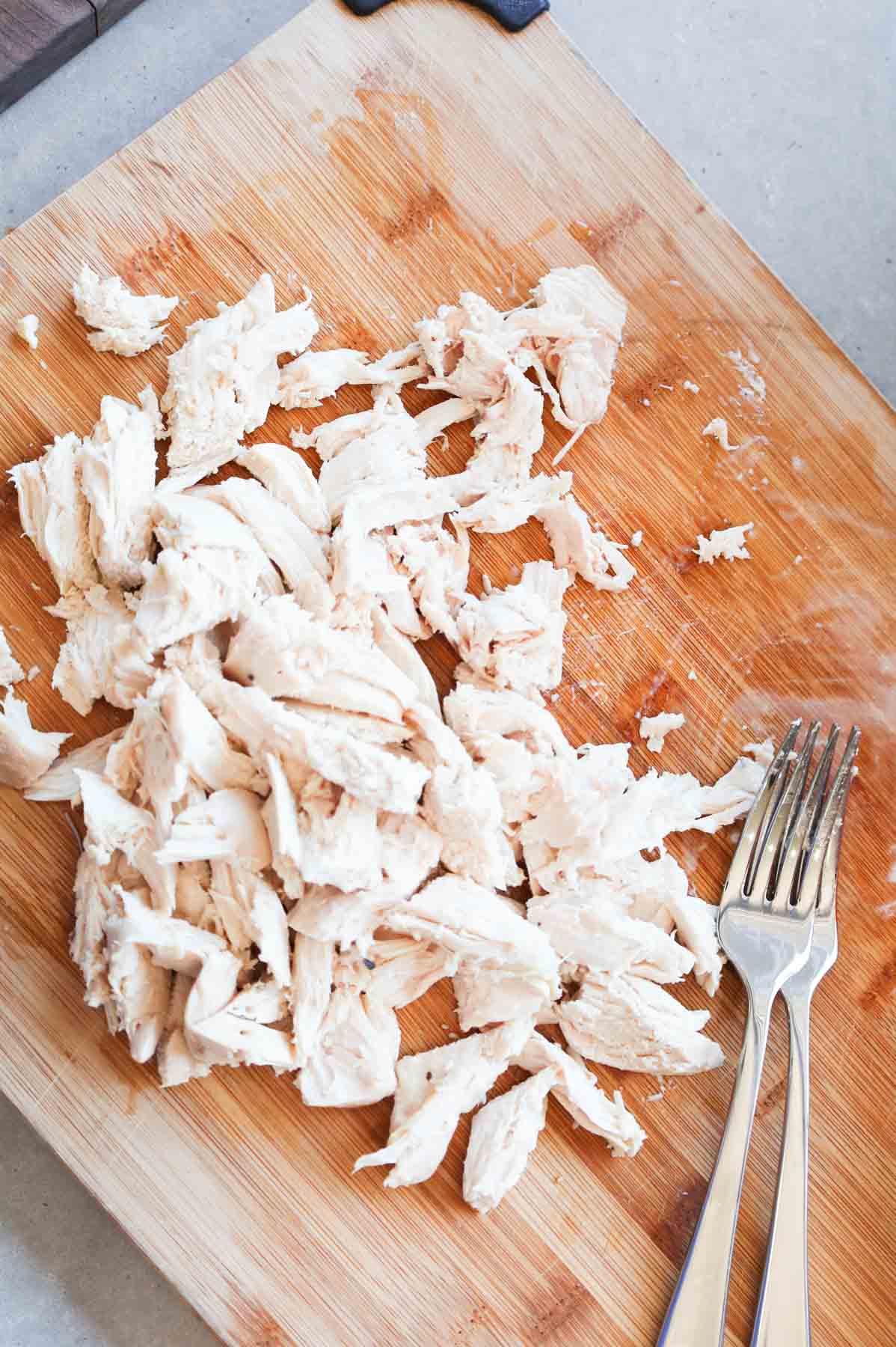 shredded chicken on a cutting board