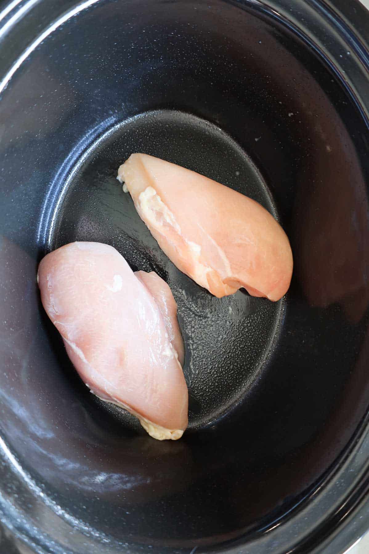 raw boneless, skinless chicken breasts in a crock pot