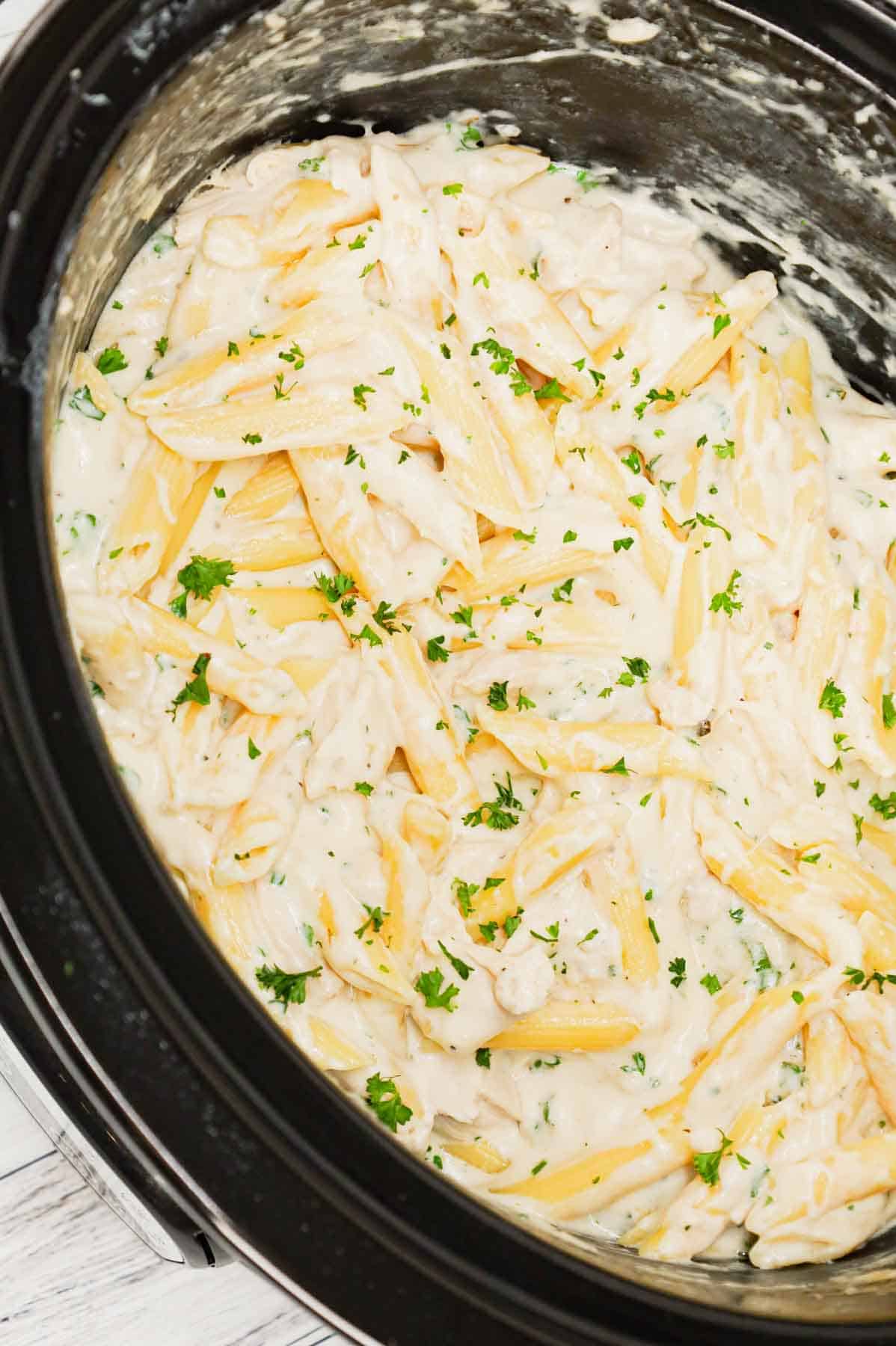 Crock Pot Garlic Parmesan Chicken Pasta is a creamy slow cooker pasta recipe loaded with cream cheese, garlic parmesan wing sauce, mozzarella, parmesan and shredded chicken breasts.