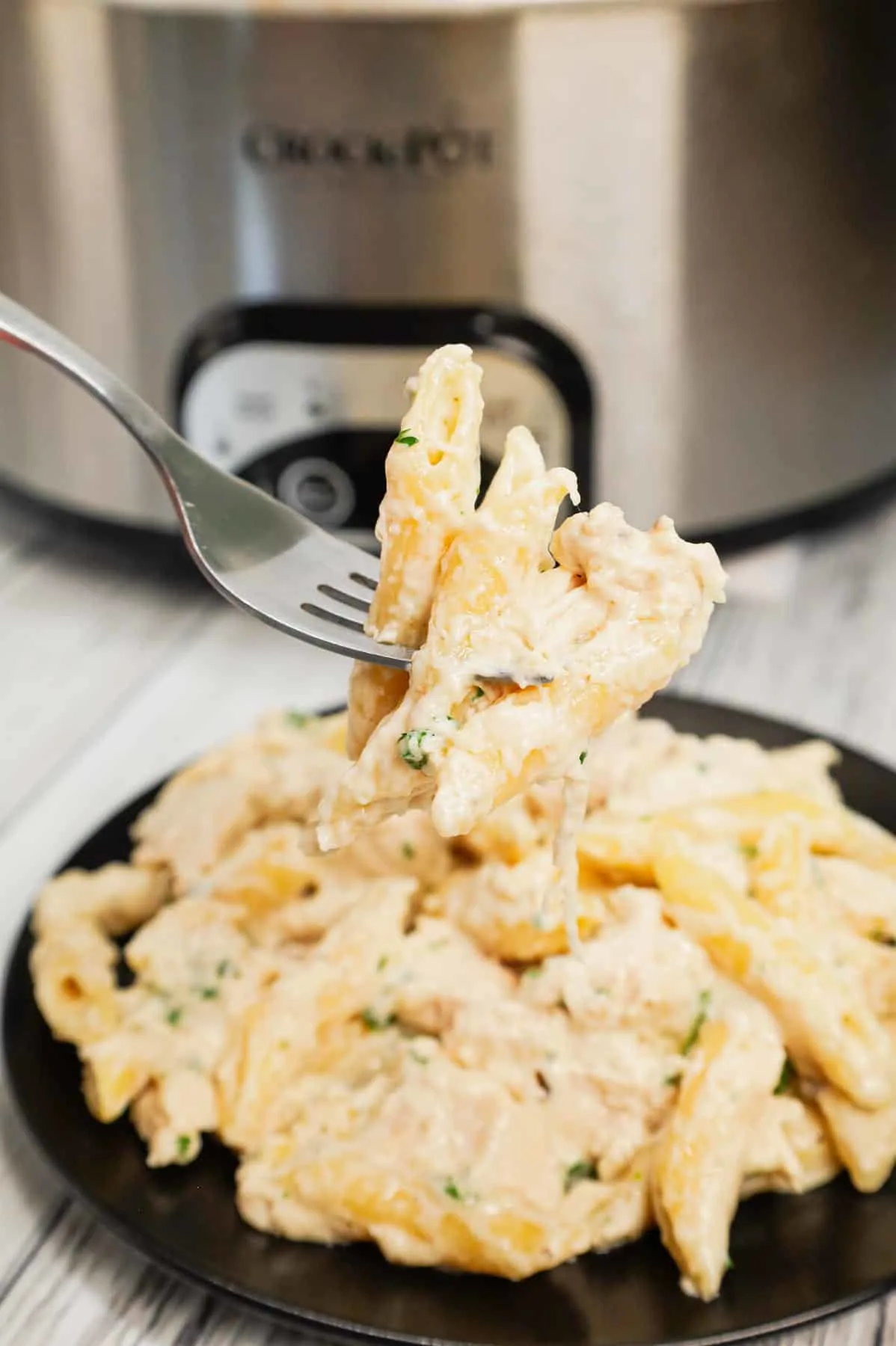 Crock Pot Garlic Parmesan Chicken Pasta is a creamy slow cooker pasta recipe loaded with cream cheese, garlic parmesan wing sauce, mozzarella, parmesan and shredded chicken breasts.