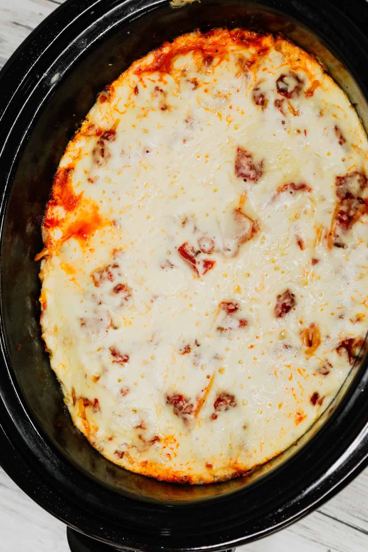 Crock Pot Million Dollar Spaghetti is a hearty slow cooker pasta recipe loaded with Italian sausage, marinara sauce, cream cheese, sour cream and mozzarella cheese.