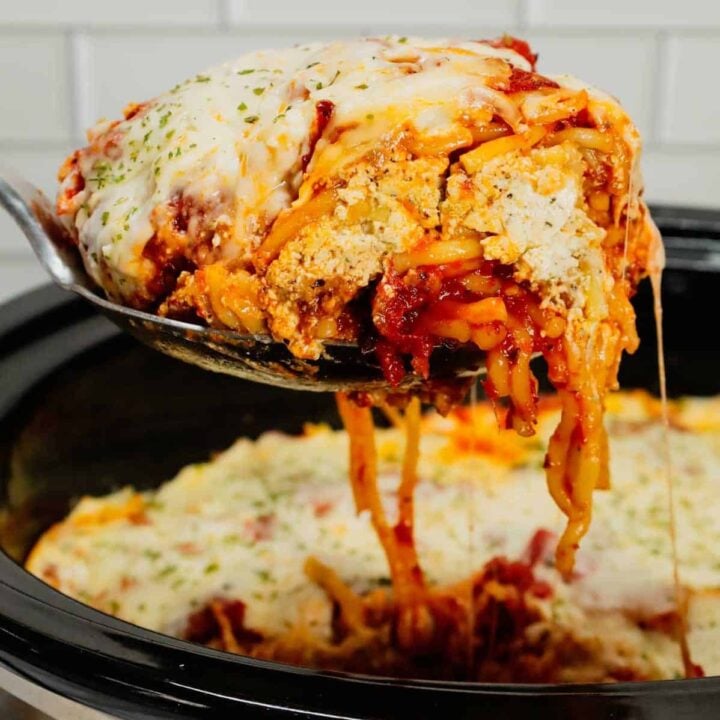 Crock Pot Million Dollar Spaghetti is a hearty slow cooker pasta recipe loaded with Italian sausage, marinara sauce, cream cheese, sour cream and mozzarella cheese.