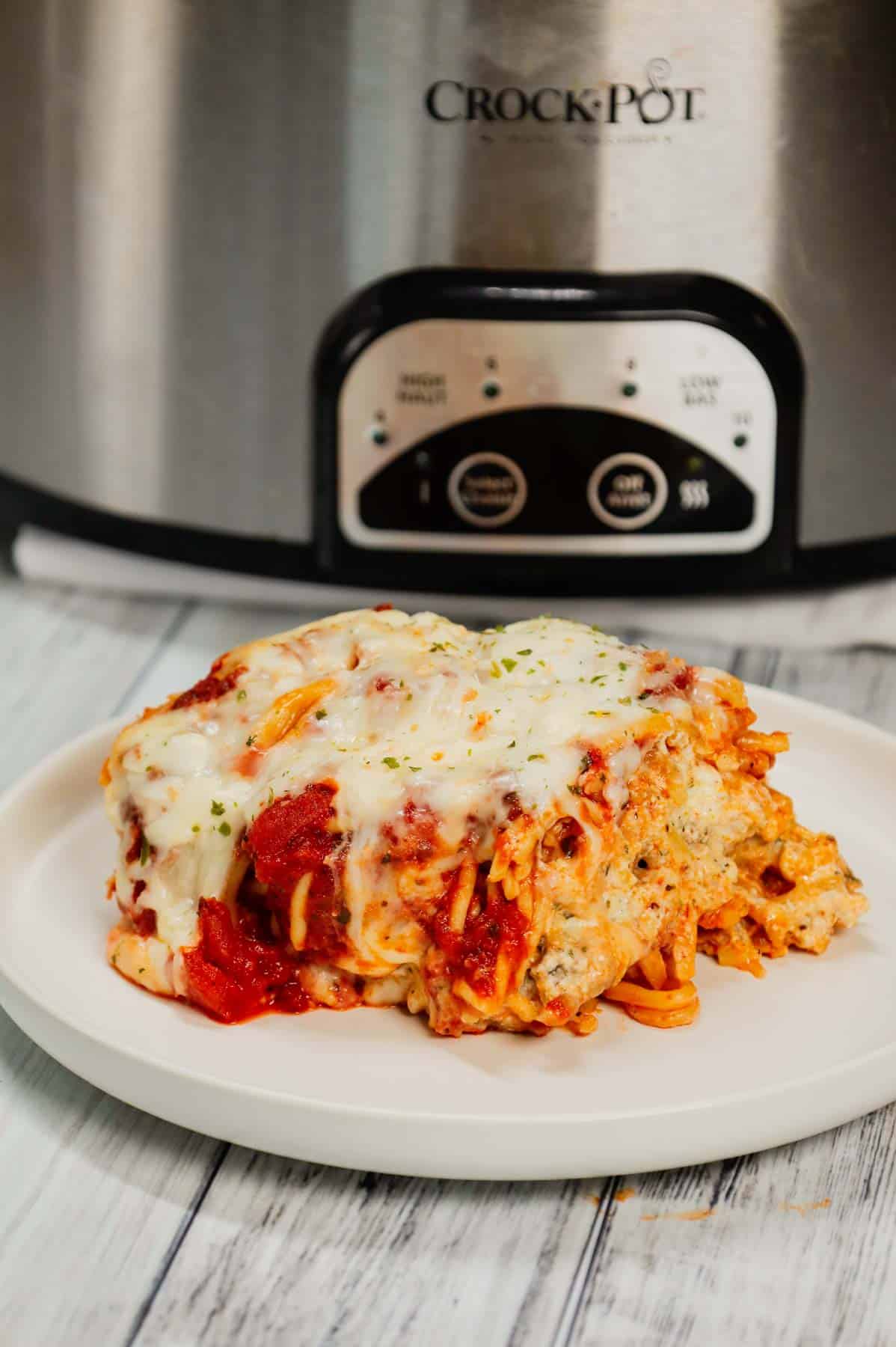 Crock Pot Million Dollar Spaghetti is a hearty slow cooker pasta recipe loaded with Italian sausage, marinara sauce, cream cheese, sour cream and mozzarella cheese.