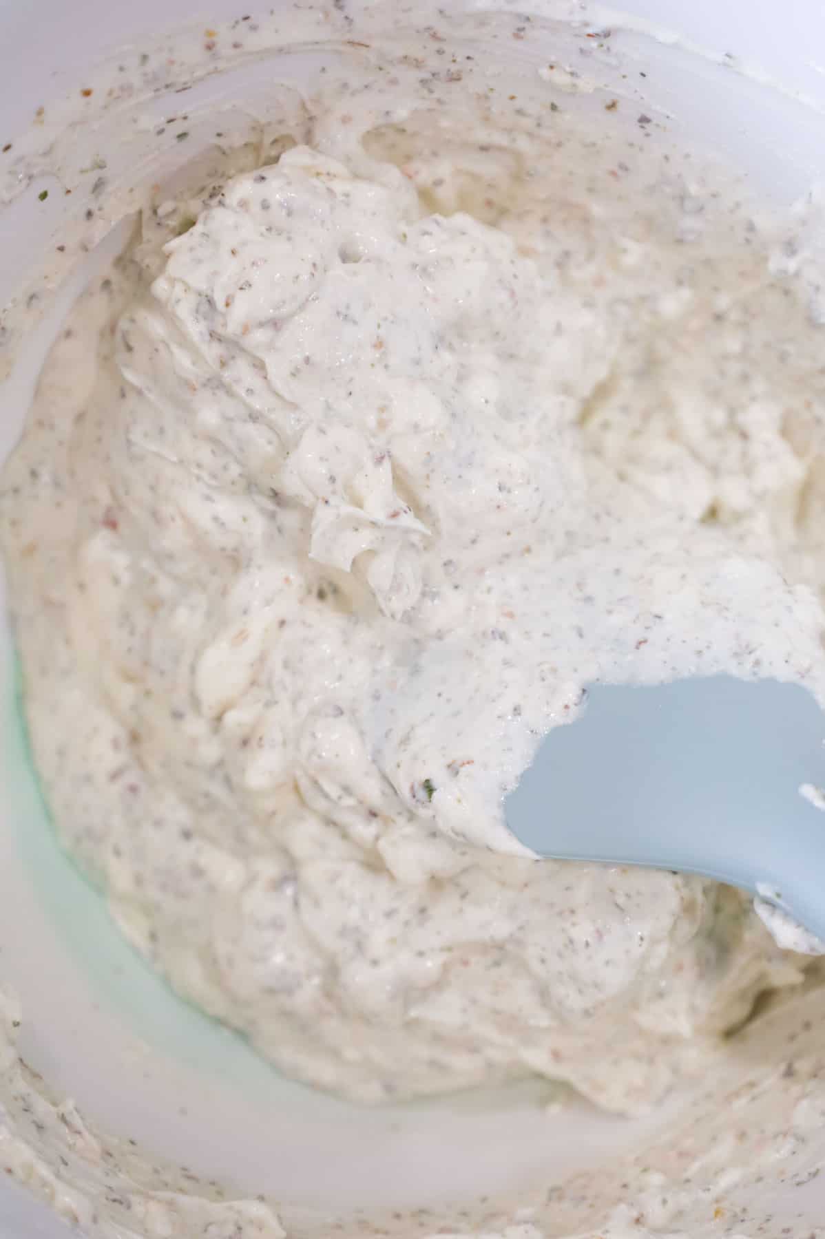 cream cheese, sour cream and Italian seasoning mixture in a mixing bowl