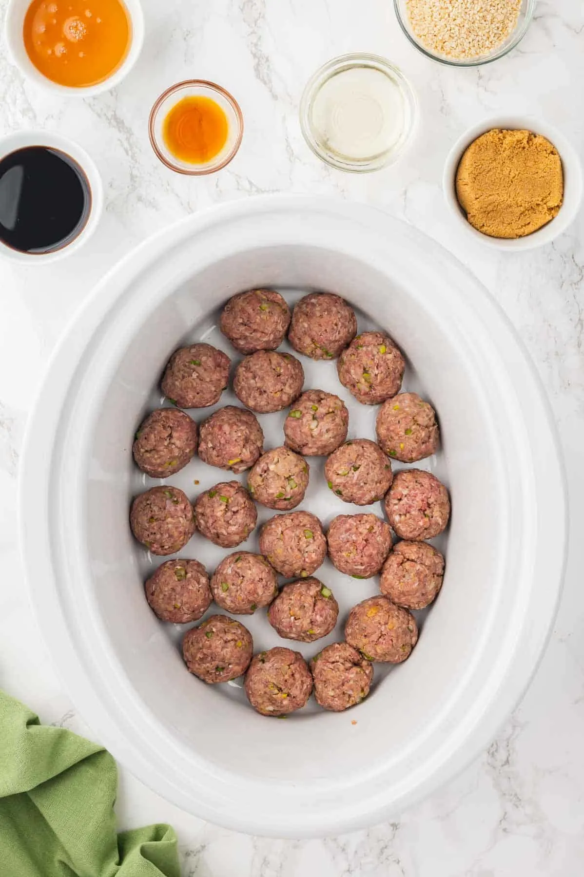 raw meatballs in the bottom of a crock pot