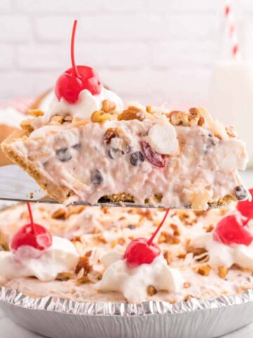 Million Dollar Pie is a creamy no bake pie loaded with crushed pineapple, chopped pecans, toasted coconut, maraschino cherries, mini marshmallows and chocolate chips all in a graham cracker crust.