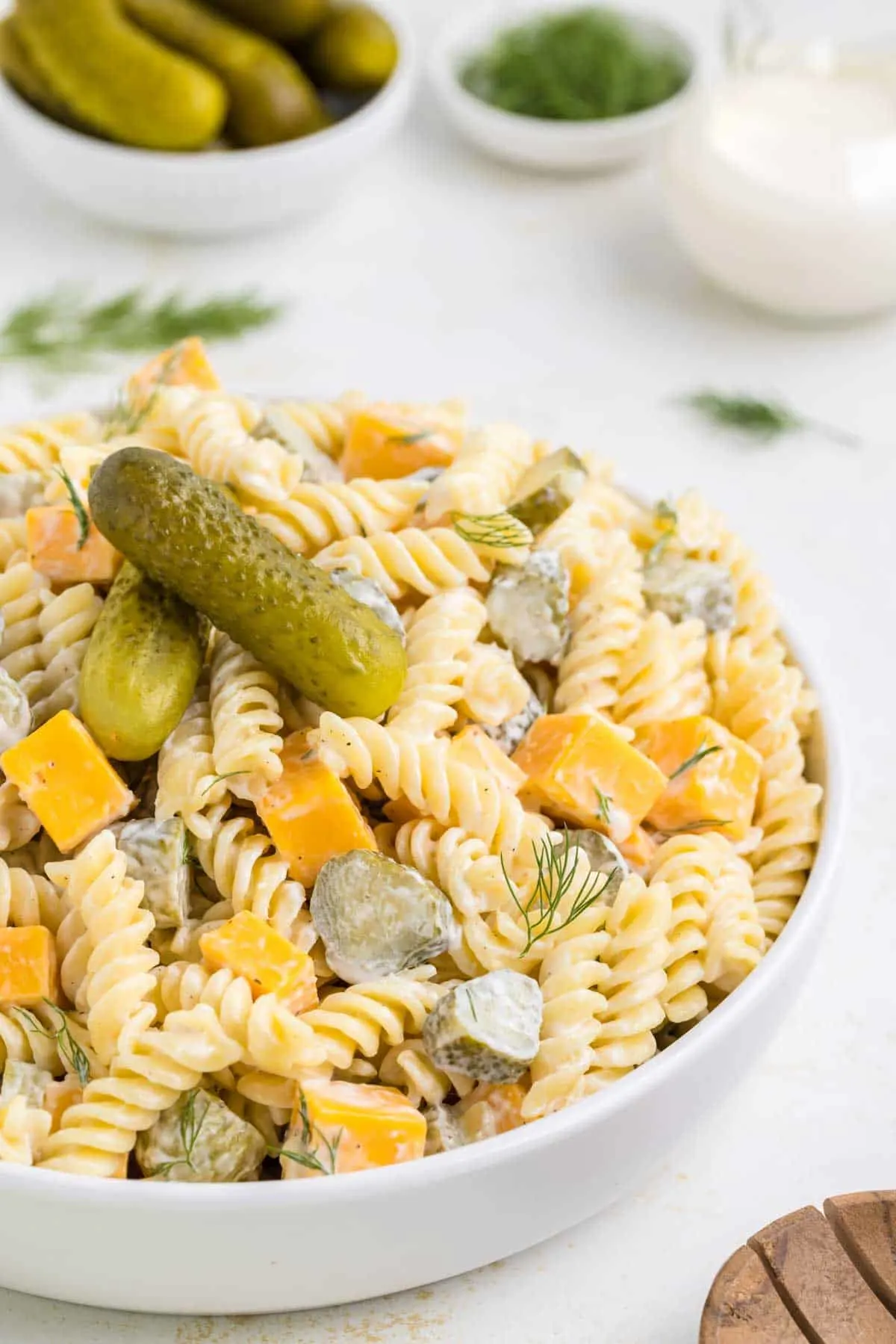 Dill Pickle Pasta Salad is a tasty cold side dish recipe made with rotini noodles and loaded with cheddar cheese, dill pickles and fresh dill all tossed in a mayo, sour cream and pickle juice dressing.