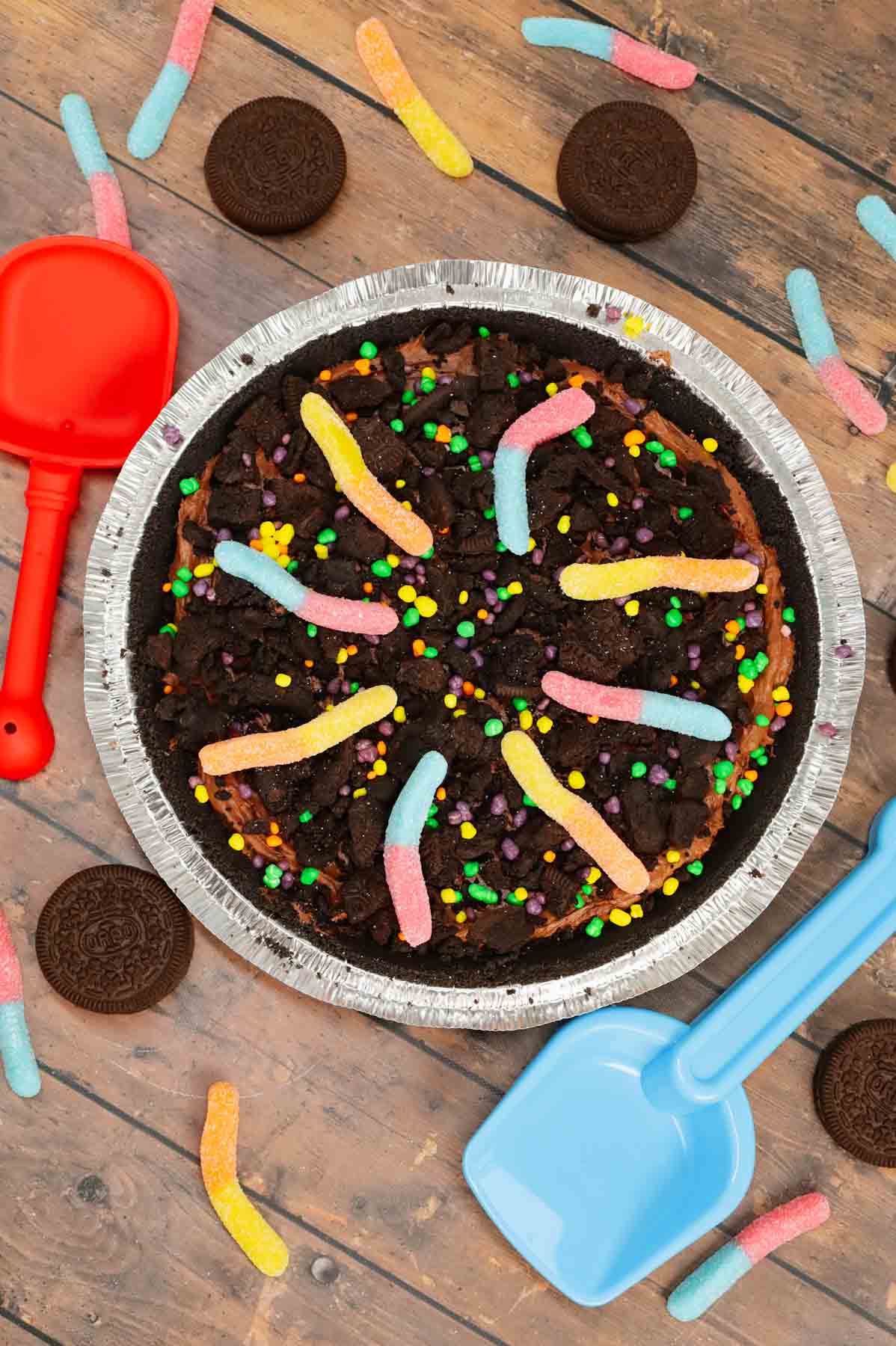 Dirt Pie is a fun and easy no bake pie recipe made with an Oreo pie crust with a chocolate filling and topped with crumbled dark chocolate Oreo cookies and gummy worms.