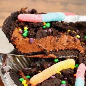 Dirt Pie is a fun and easy no bake pie recipe made with an Oreo pie crust with a chocolate filling and topped with crumbled dark chocolate Oreo cookies and gummy worms.