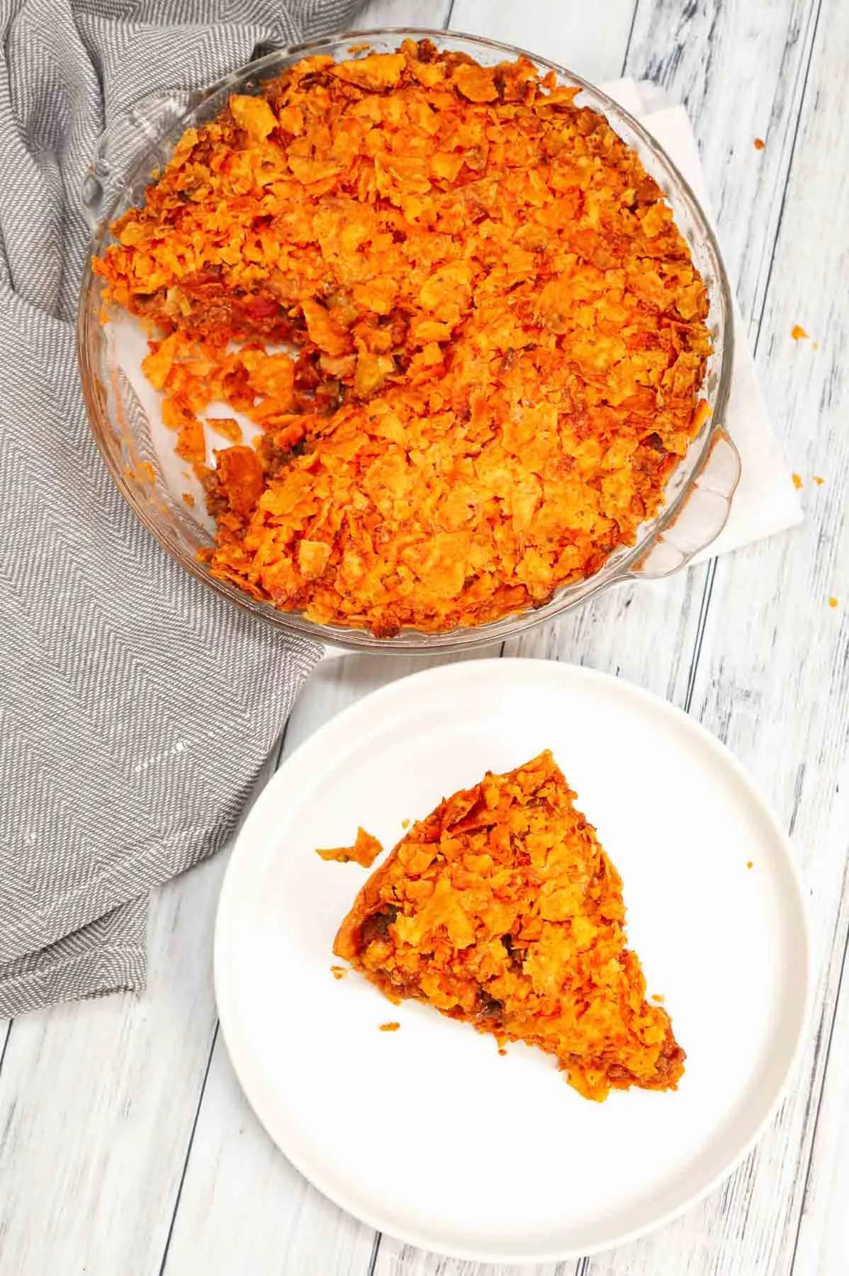 Dorito Taco Pie is an easy ground beef dinner recipe using a store bought deep dish pie crust loaded with crumbled Doritos nacho chips, beef taco meat, ranch dressing, salsa and shredded cheese.