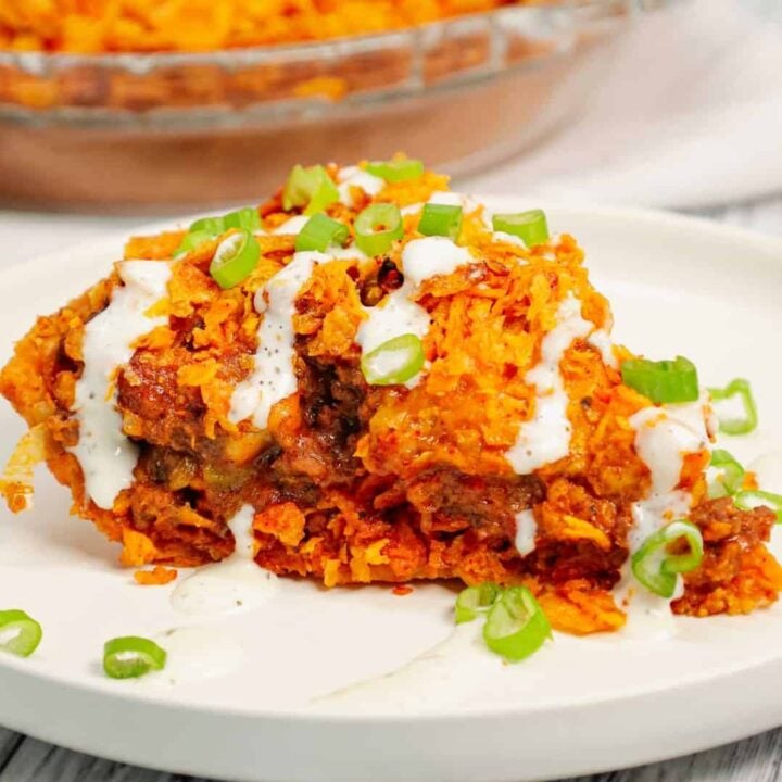 Dorito Taco Pie is an easy ground beef dinner recipe using a store bought deep dish pie crust loaded with crumbled Doritos nacho chips, beef taco meat, ranch dressing, salsa and shredded cheese.