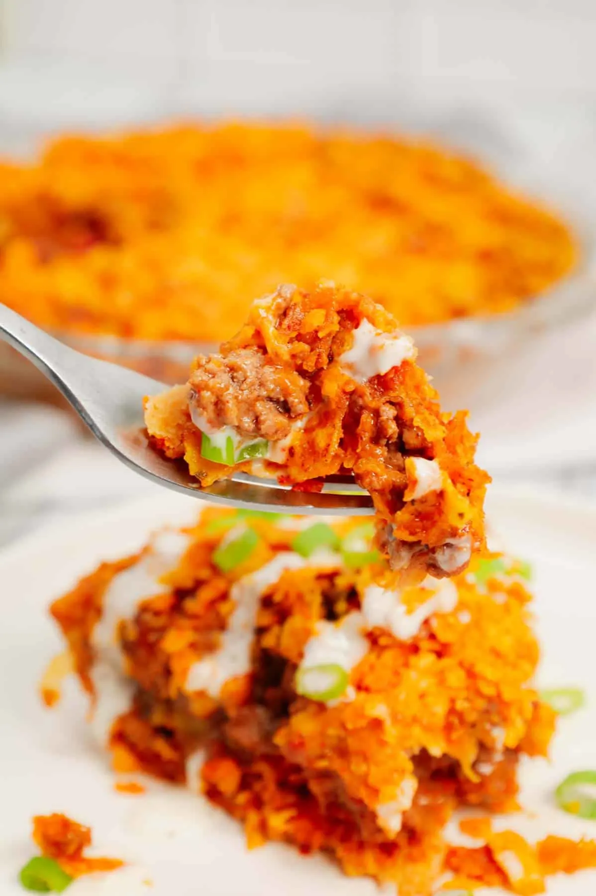 Dorito Taco Pie is an easy ground beef dinner recipe using a store bought deep dish pie crust loaded with crumbled Doritos nacho chips, beef taco meat, ranch dressing, salsa and shredded cheese.